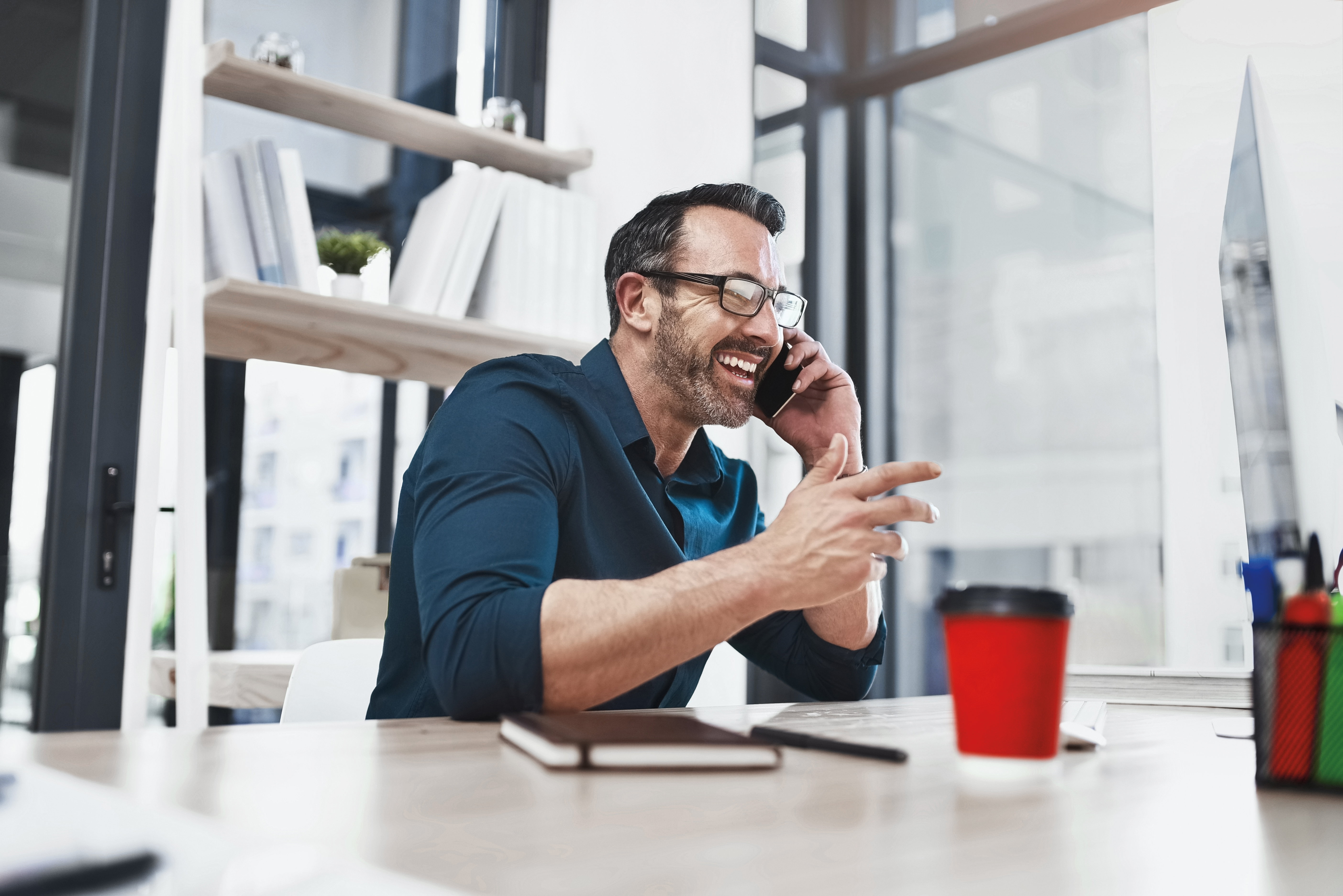 Man in blue short talking on phone